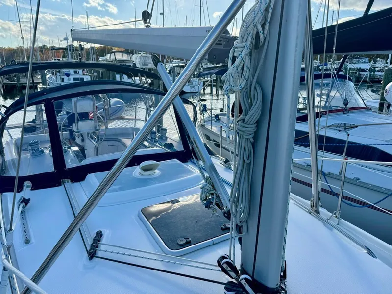 Slide: The Image of 2002 Hunter 356 sailboat docked at marina, featuring sleek deck and rigging. - 38
