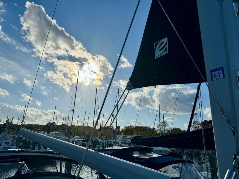 Slide: The Image of Sailboat Hunter 356, 2002 model, docked under a bright blue sky with scattered clouds. - 39