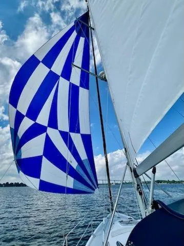 Slide: The Image of Sailboat with blue and white spinnaker on water, Hunter 356, 2002 model. - 8