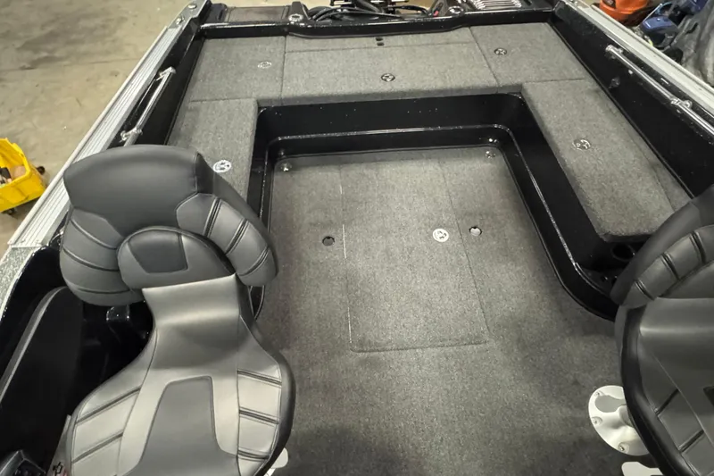 Slide: The Image of 2024 Nitro ZV20 boat interior with gray carpet and black seats. - 11