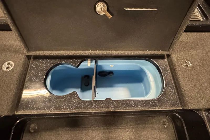 Slide: The Image of 2024 Nitro ZV20 boat storage compartment with blue interior and secure lock. - 13