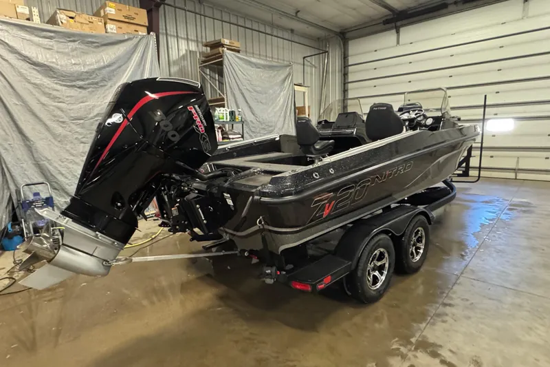 Slide: The Image of 2024 Nitro ZV20 boat in a garage, featuring a powerful outboard motor. - 3