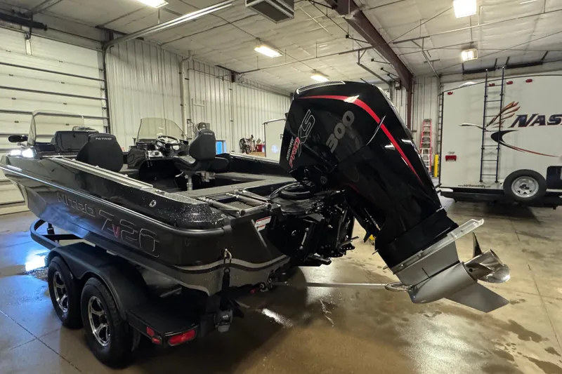 Slide: The Image of 2024 Nitro ZV20 boat with powerful outboard motor in a spacious garage. - 4