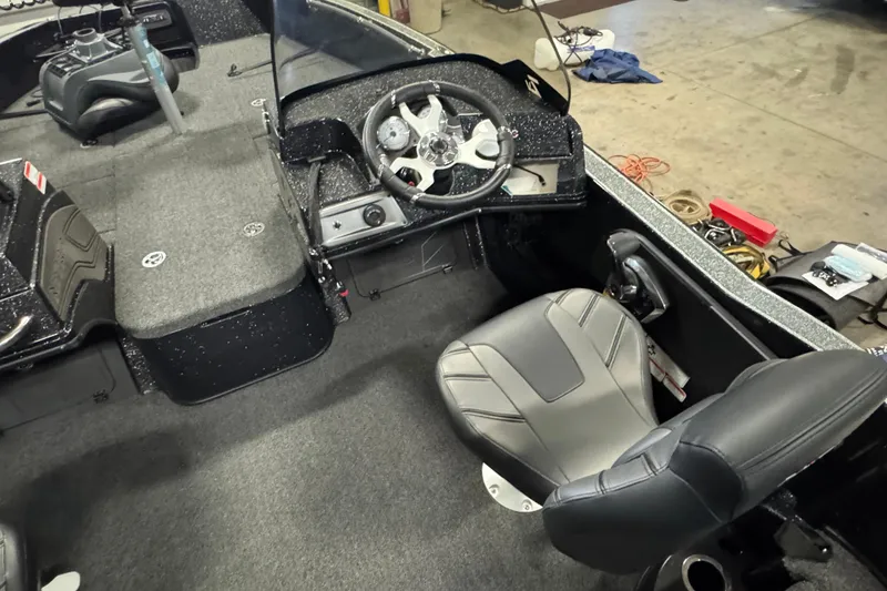 Slide: The Image of 2024 Nitro ZV20 boat interior with steering wheel and seating in a workshop setting. - 6