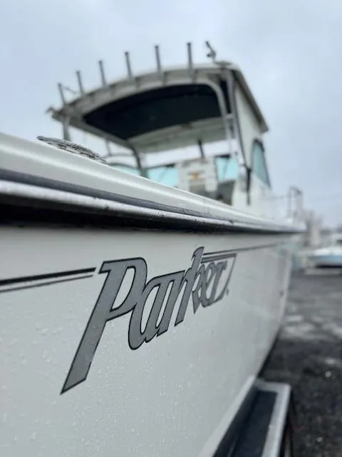 Slide: The Image of 2015 Parker 2510 XLD boat with sleek design, docked on a cloudy day. - 12