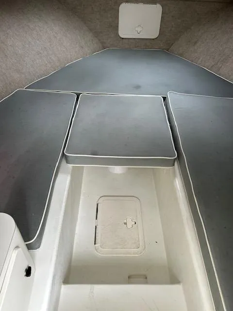 Slide: The Image of 2015 Parker 2510 XLD boat interior with cushioned seating and storage compartment. - 17