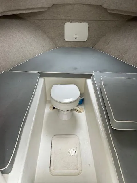 Slide: The Image of 2015 Parker 2510 XLD boat interior with toilet and cushioned seating. - 19