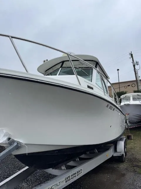 Slide: The Image of 2015 Parker 2510 XLD boat on trailer, overcast day, marina background. - 6