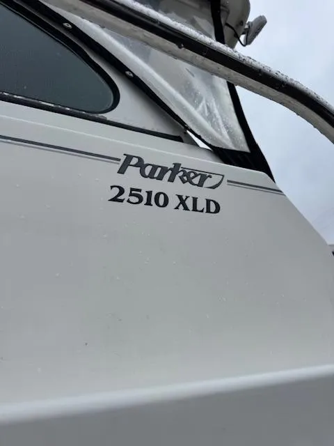 Slide: The Image of 2015 Parker 2510 XLD boat exterior with logo and railing. - 7