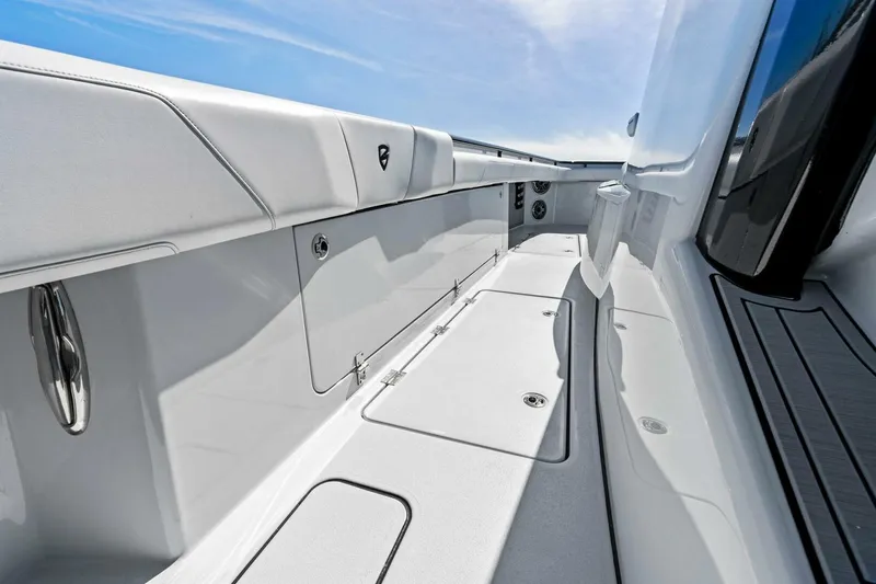 Slide: The Image of 2024 Barker Boatworks 40 High Performance Cat interior, sleek white design under blue sky. - 15