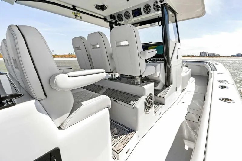 Slide: The Image of 2024 Barker Boatworks 40 High Performance Cat interior with sleek seating and modern controls. - 19