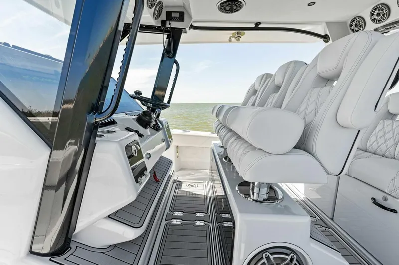 Slide: The Image of 2024 Barker Boatworks 40 High Performance Cat interior with luxurious seating and modern controls. - 25