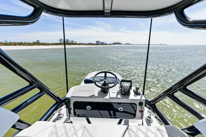 Slide: The Image of 2024 Barker Boatworks 40 High Performance Cat on open water, showcasing helm and ocean view. - 30
