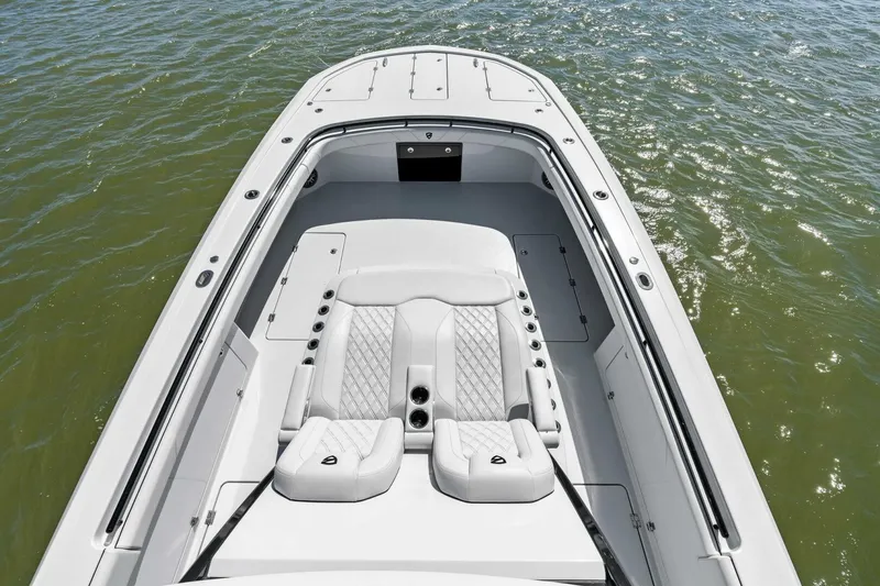 Slide: The Image of 2024 Barker Boatworks 40 High Performance Cat on water, showcasing sleek design and seating. - 32