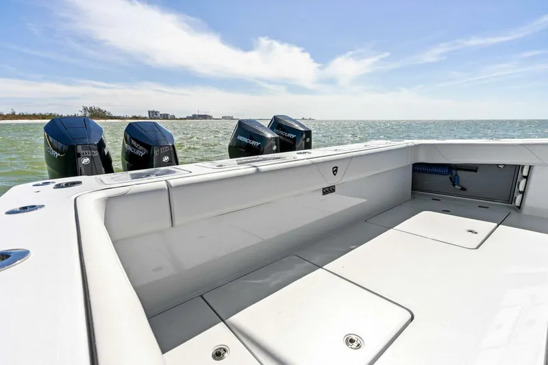 Slide: The Image of 2024 Barker Boatworks 40 High Performance Cat with powerful outboard engines on open water. - 38