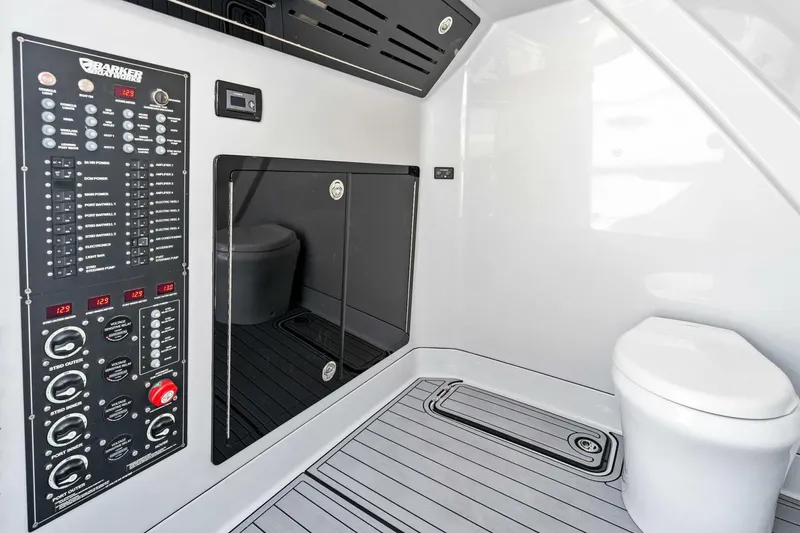 Slide: The Image of 2024 Barker Boatworks 40 High Performance Cat interior with control panel and modern toilet. - 43