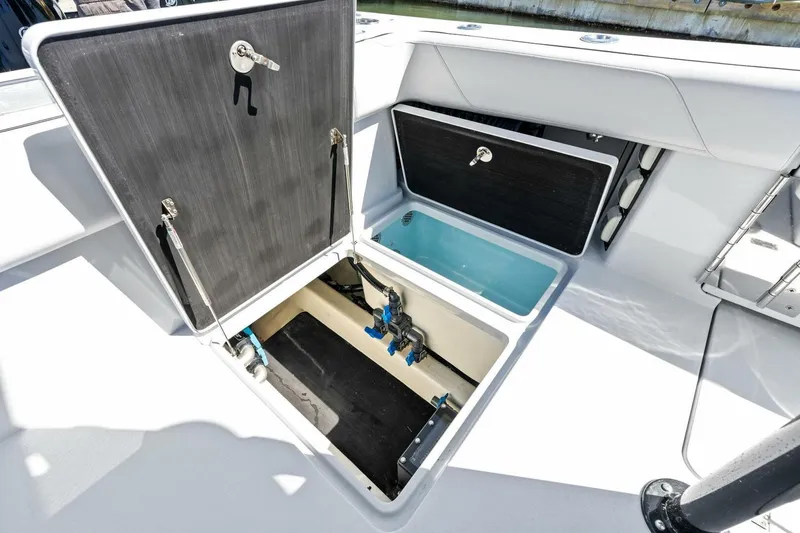 Slide: The Image of 2024 Barker Boatworks 40 High Performance Cat storage compartments open on deck. - 44