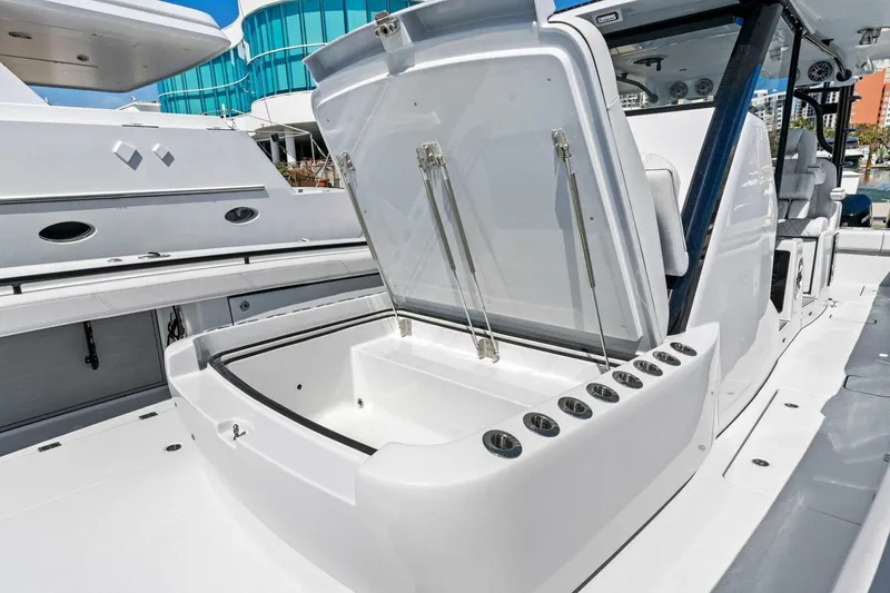 Slide: The Image of 2024 Barker Boatworks 40 High Performance Cat with open storage compartment. - 49