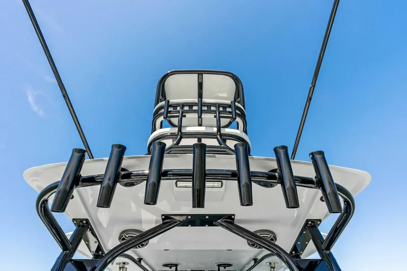 Slide: The Image of 2024 Barker Boatworks 40 High Performance Cat, sleek design against clear blue sky. - 5