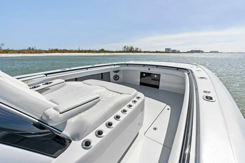 Slide: The Image of 2024 Barker Boatworks 40 High Performance Cat on calm waters, showcasing sleek design and luxury seating. - 7