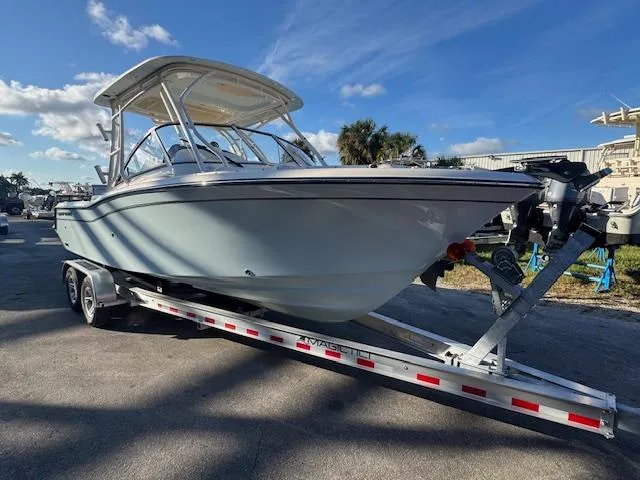 The Image of 2025 Grady-White Freedom 235 boat on trailer under clear blue sky. - 1