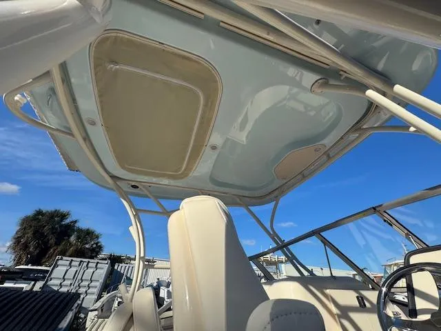 Slide: The Image of 2025 Grady-White Freedom 235 boat interior with canopy, under clear blue sky. - 11