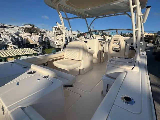 Slide: The Image of 2025 Grady-White Freedom 235 boat interior with seating and helm, displayed outdoors. - 3