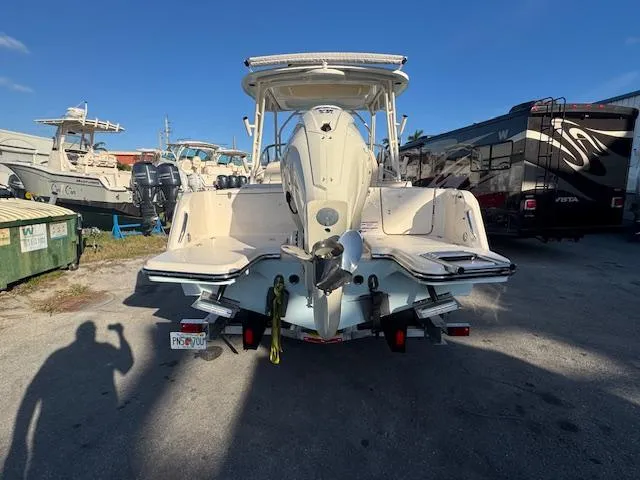 Slide: The Image of 2025 Grady-White Freedom 235 boat, rear view, parked outdoors on a sunny day. - 5