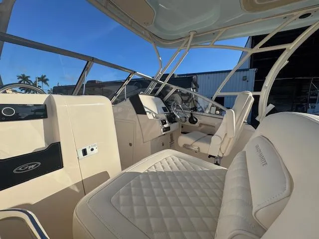 Slide: The Image of 2025 Grady-White Freedom 235 boat interior with luxurious seating and modern dashboard. - 9