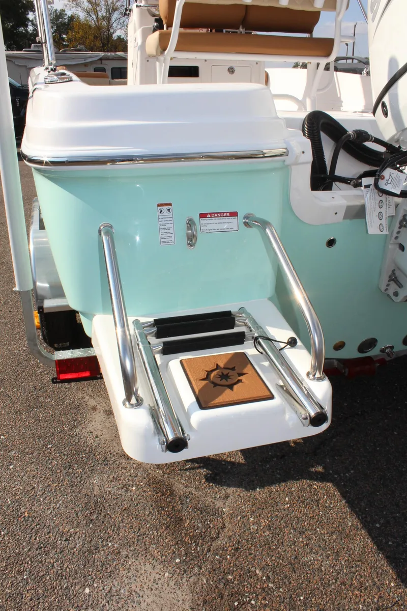 Slide: The Image of 2025 NauticStar 231 Hybrid boat with swim platform and ladder, rear view. - 10