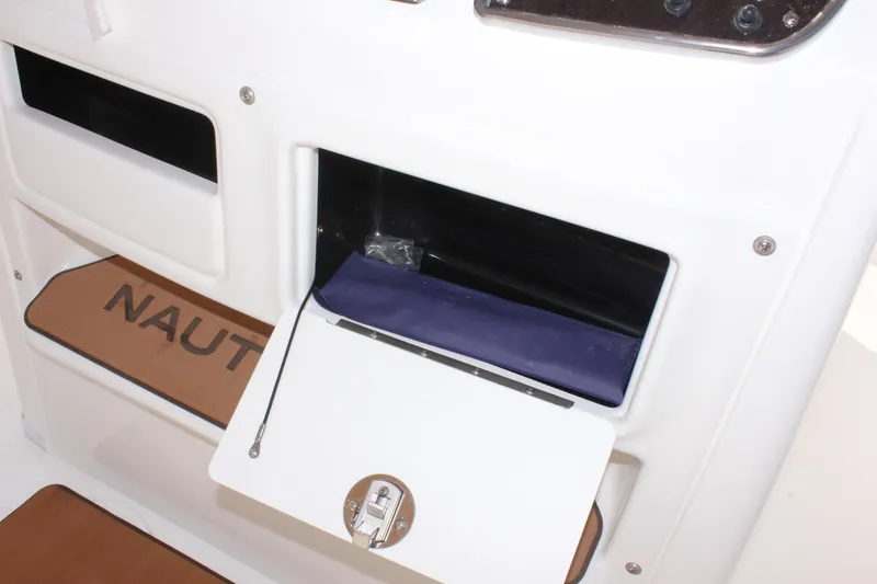 Slide: The Image of 2025 NauticStar 231 Hybrid storage compartment with open hatch and visible interior. - 18