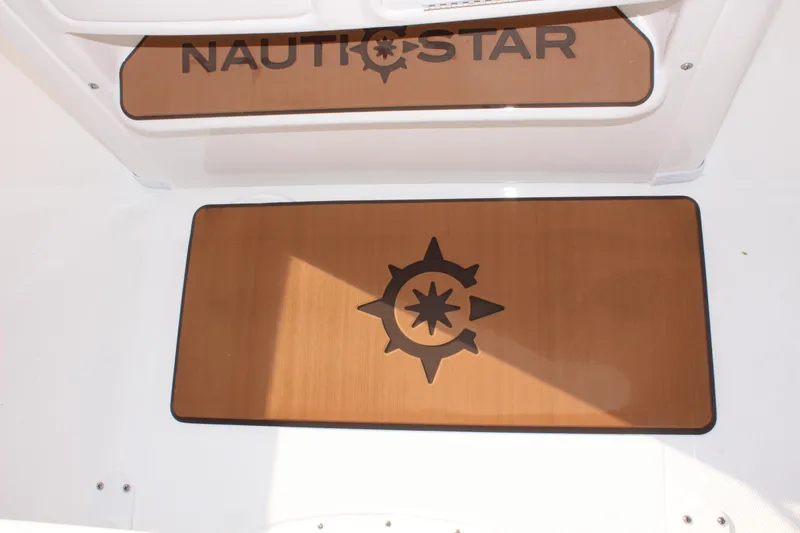 Slide: The Image of NauticStar 231 Hybrid 2025 boat interior with compass design mat. - 19