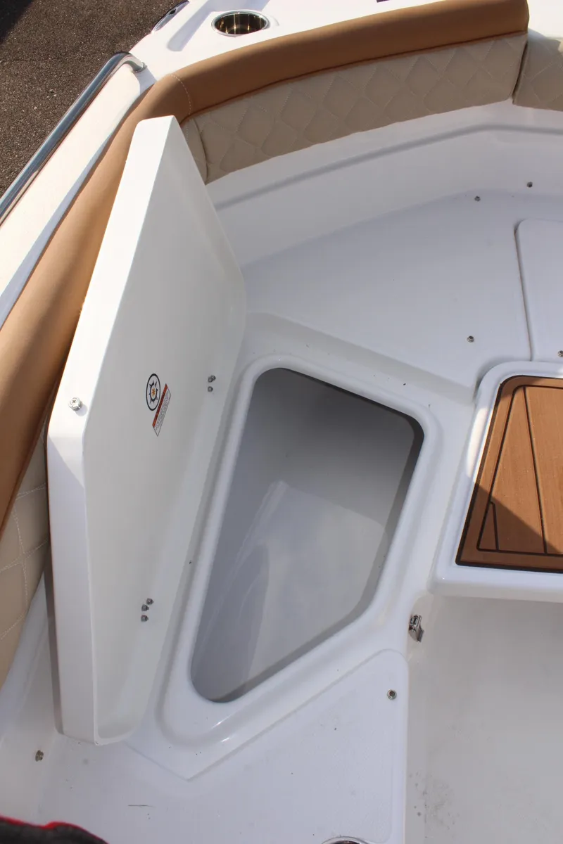 Slide: The Image of 2025 NauticStar 231 Hybrid boat storage compartment with cushioned seating. - 25