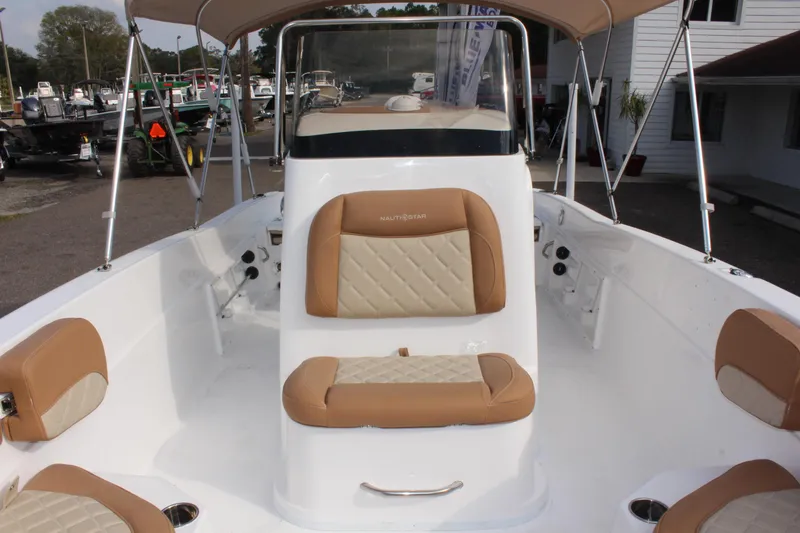 Slide: The Image of 2025 NauticStar 231 Hybrid boat interior with tan and white seating. - 30