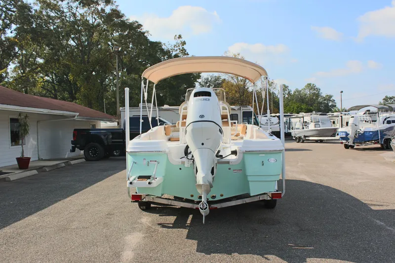 Slide: The Image of 2025 NauticStar 231 Hybrid boat in a marina parking lot. - 8