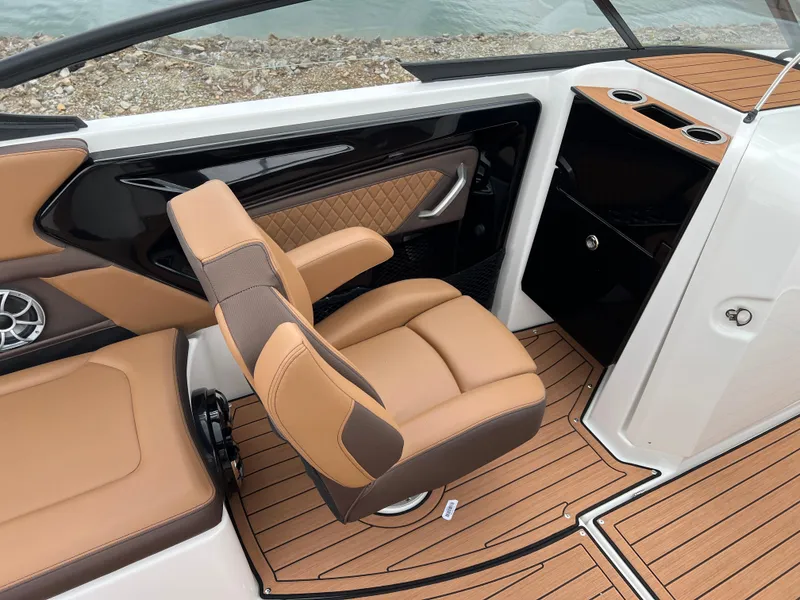 Slide: The Image of 2025 Yamaha Boats 252S interior with tan seating and wood-style flooring. - 13