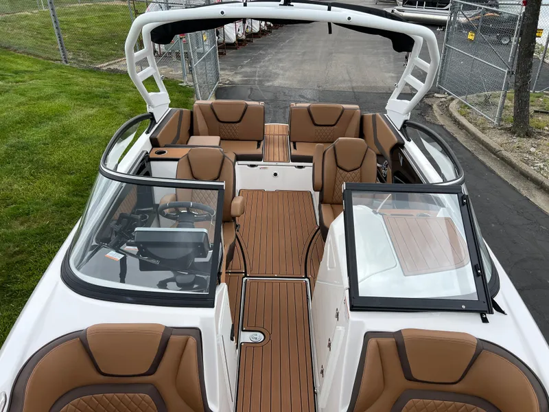 Slide: The Image of 2025 Yamaha Boats 252S interior with brown seating and sleek design. - 19