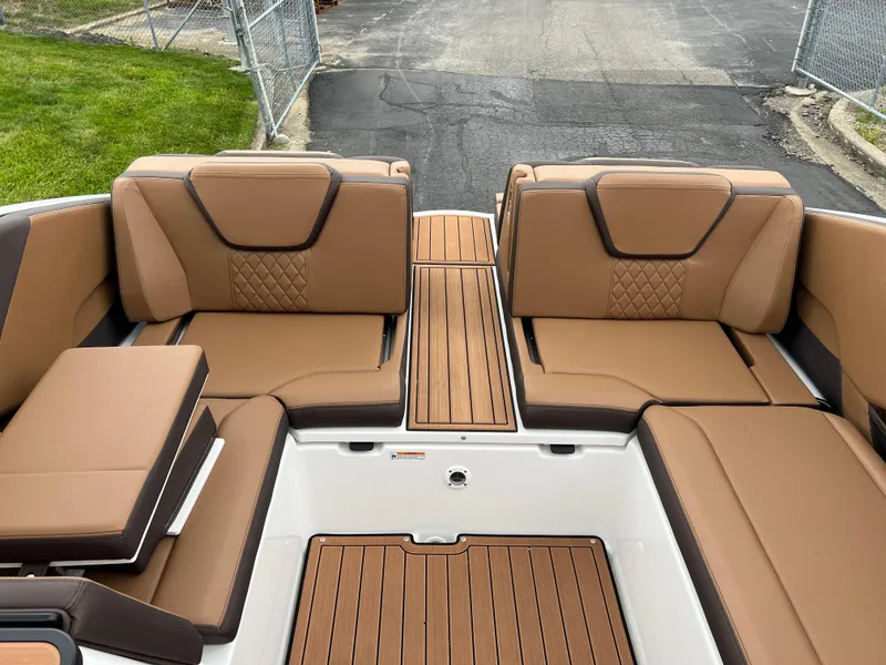 Slide: The Image of 2025 Yamaha Boats 252S interior with tan leather seating and wood accents. - 21