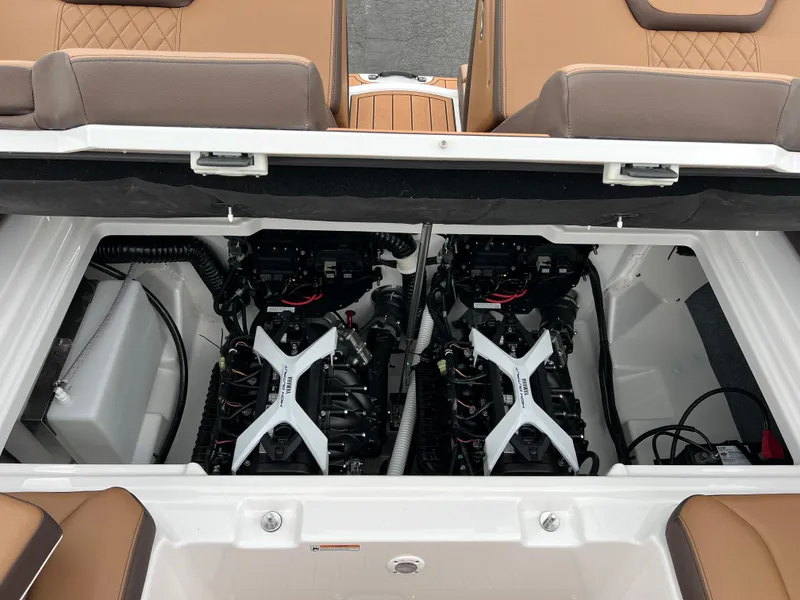 Slide: The Image of 2025 Yamaha Boats 252S engine compartment with dual engines and tan seating. - 23