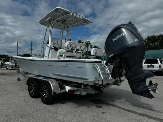 Slide: The Image of 2025 BlackJack 224 boat with Yamaha engine on trailer, parked outdoors. - 3