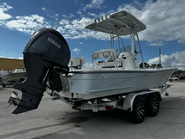 Slide: The Image of 2025 BlackJack 224 boat with Yamaha engine on trailer under cloudy sky. - 4