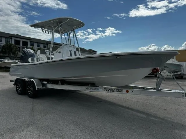 Slide: The Image of 2025 BlackJack 224 boat on trailer under cloudy sky. - 6