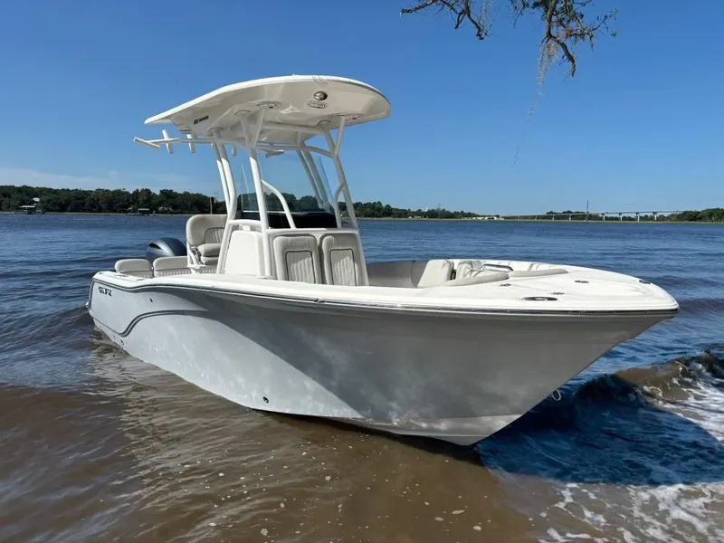 Slide: The Image of 2020 Sea Fox 228 Commander boat on a sunny day by the water. - 2