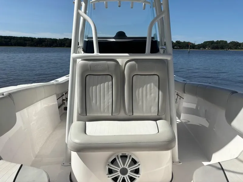 Slide: The Image of 2020 Sea Fox 228 Commander boat interior with seating and speaker, on calm water. - 4