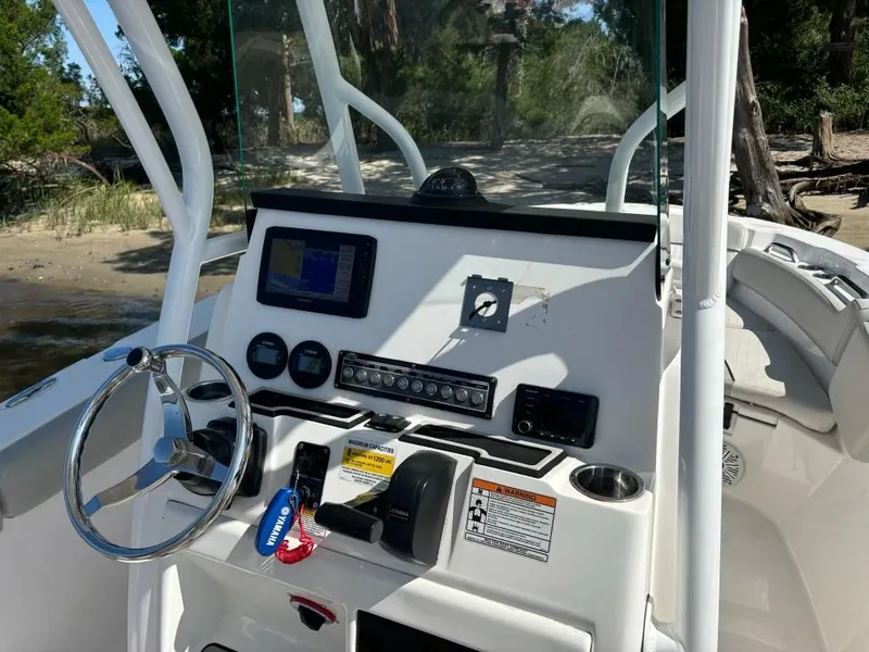 Slide: The Image of 2020 Sea Fox 228 Commander boat dashboard with steering wheel and navigation controls. - 5