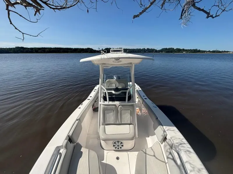Slide: The Image of 2020 Sea Fox 228 Commander boat on calm lake under clear blue sky. - 7