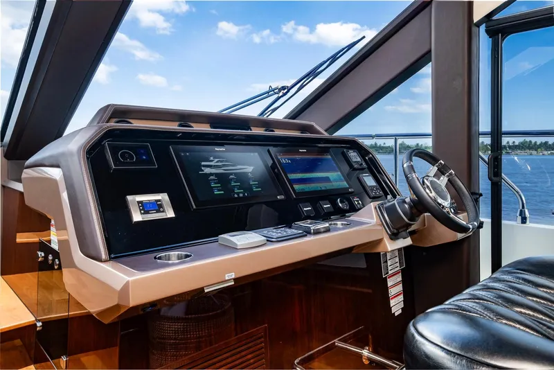 Slide: The Image of Galeon 640 Fly 2020 yacht helm with modern navigation controls and leather seating. - 27