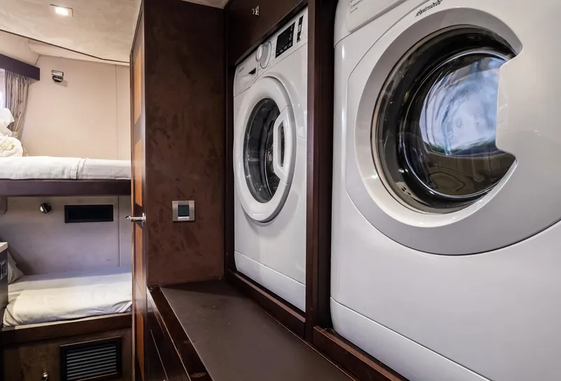 Slide: The Image of Laundry area with washer and dryer inside 2020 Galeon 640 Fly yacht cabin. - 44