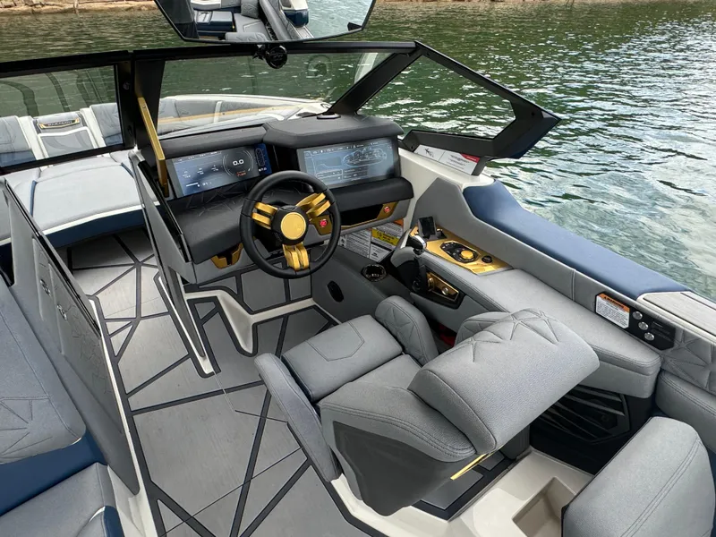 Slide: The Image of 2024 Nautique Super Air Nautique G25 Paragon interior with modern dashboard and luxurious seating. - 12