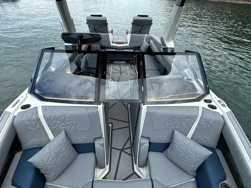 Slide: The Image of 2024 Nautique Super Air Nautique G25 Paragon interior with luxurious seating on the water. - 16